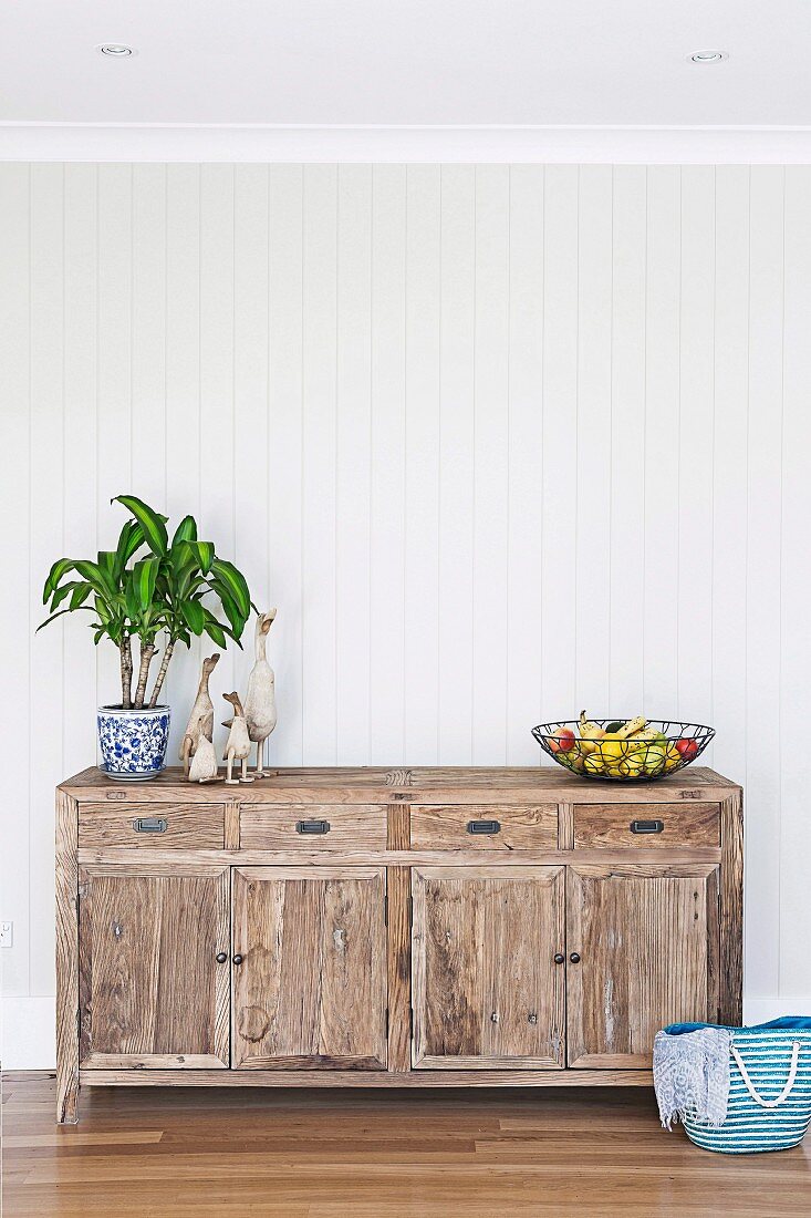 Rustic wooden chest of drawers with summery decoration