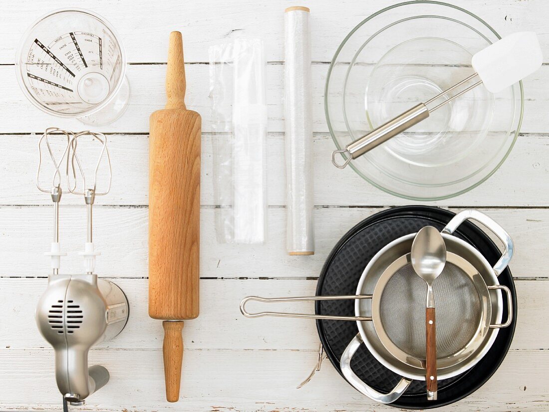 Kitchen utensils for making a raspberry cream cake with a biscuit base