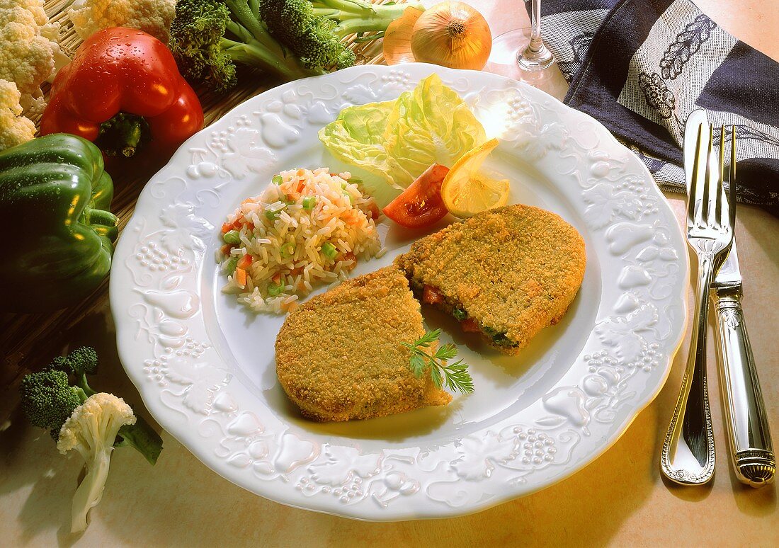 Möhren-Erbsen-Puffer mit Gemüsereis auf Teller