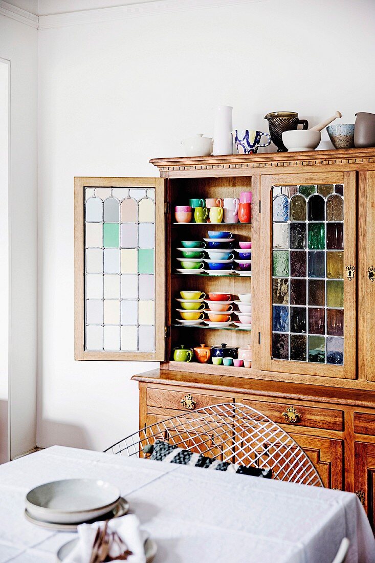 Open kitchen buffet with stained glass and different colored dishes