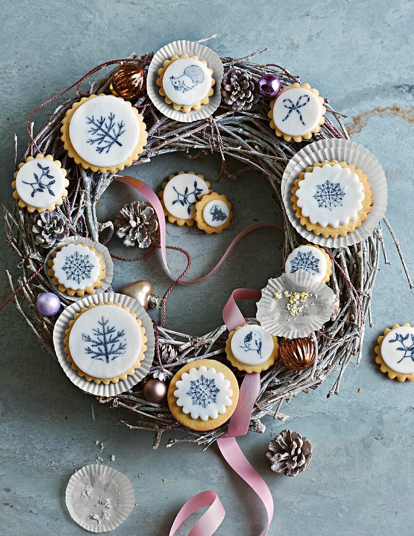 Fondant biscuits with stamp print decorations on a Christmas wreath