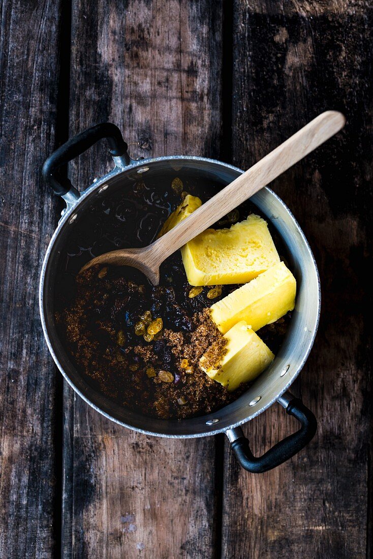 Ingredients for spelt and amaretto fruit cake in a saucepan