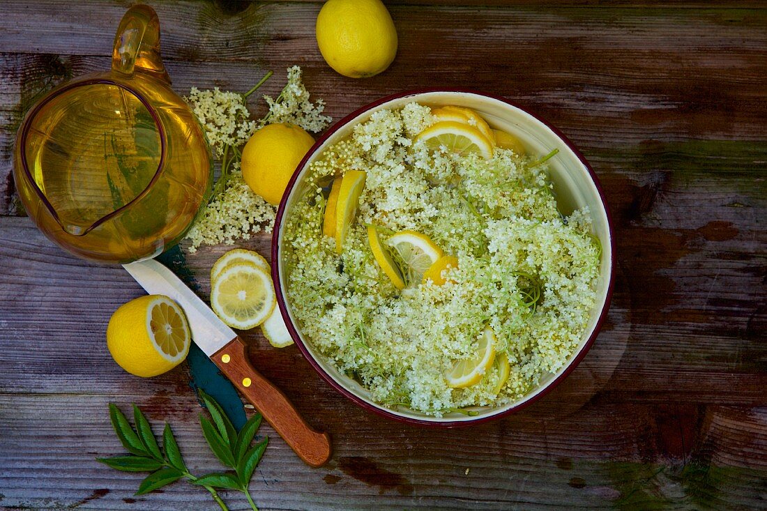 Elderflower syrup being made with lemon slices