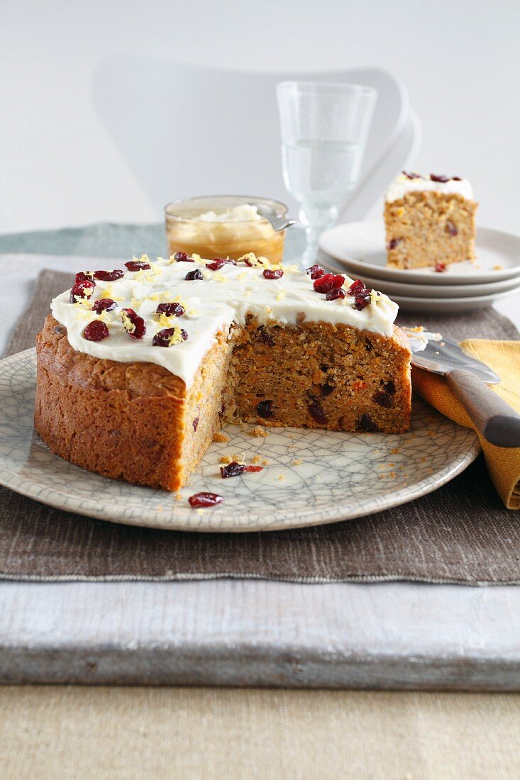 Carrot cake with dried cranberries, a piece cut