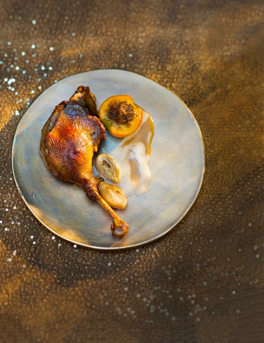 Goose leg with baked apple and chestnuts