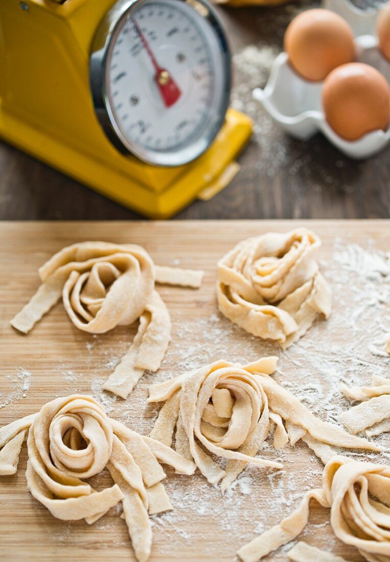 Homemade tagliatelle on a wooden board