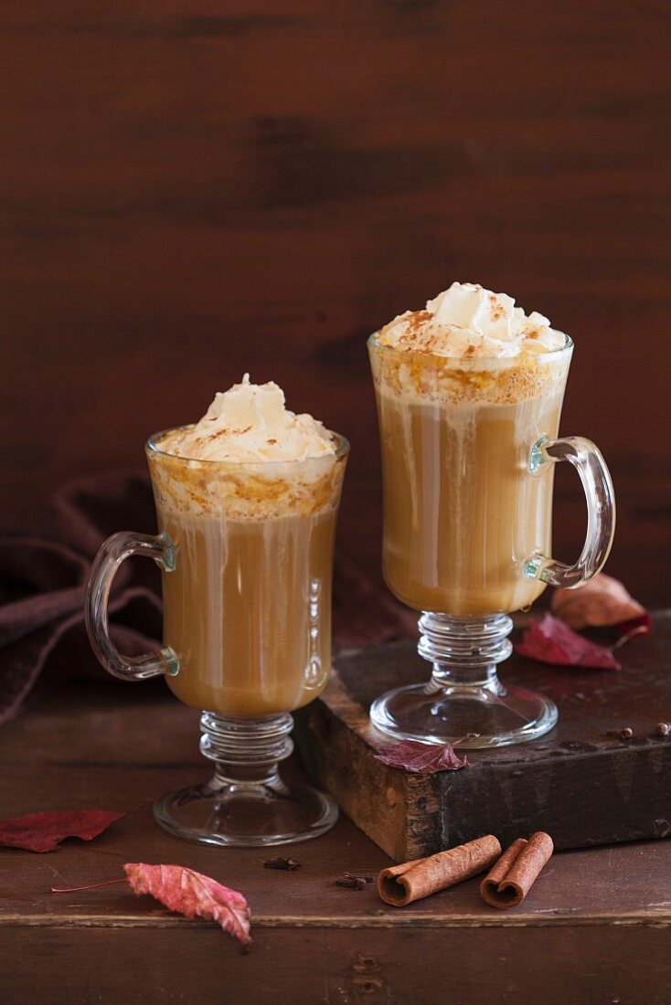 Pumpkin latte with whipped cream and maple syrup