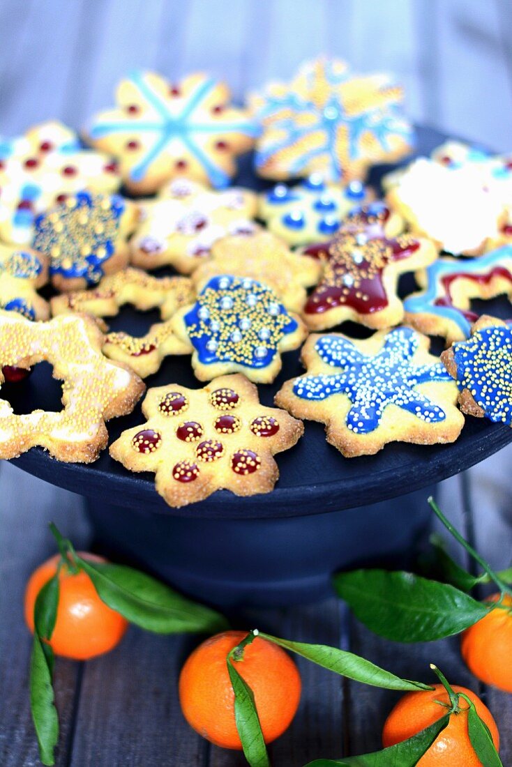 Assorted gingerbreads with colourful icing on a cake stand