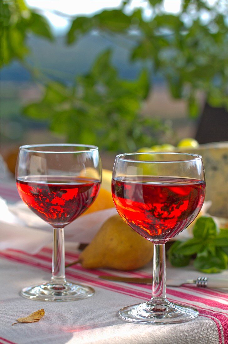 Two glasses of rosé wine on table outdoors
