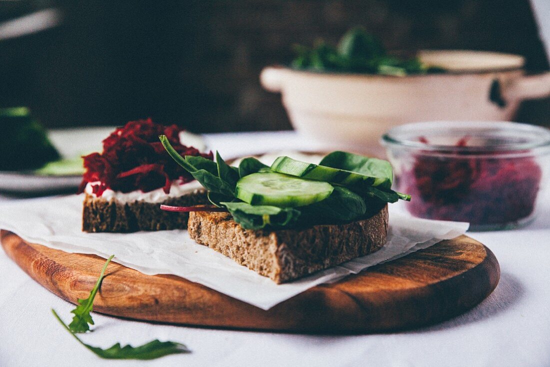Slices of bread topped with beetroot and cucumber