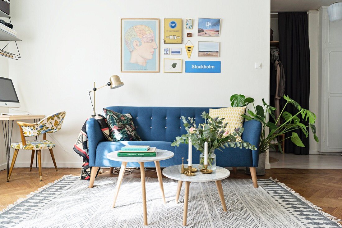 Blue retro sofa, standard lamp and side table in living room