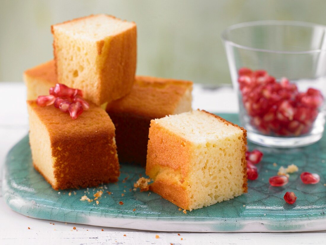 Lime cake cubes with yogurt and pomegranate seeds
