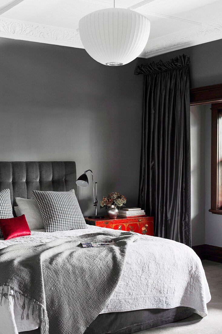 Elegant bedroom in shades of gray with red accents