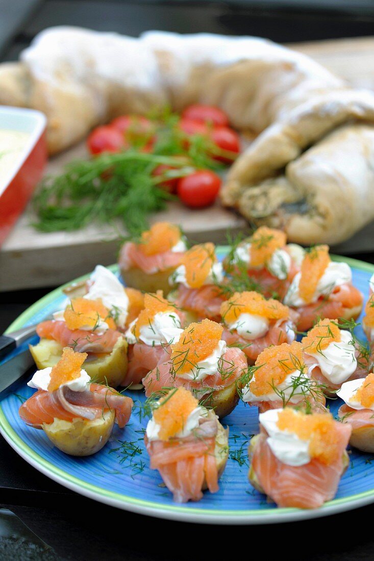 Salted salmon on potato with sour cream and roe