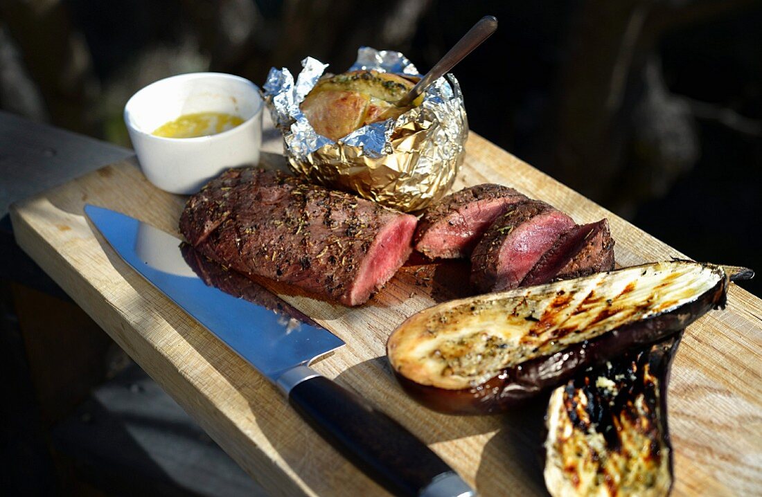 Grilled lamb fillet with rosemary butter, baked potato and aubergine