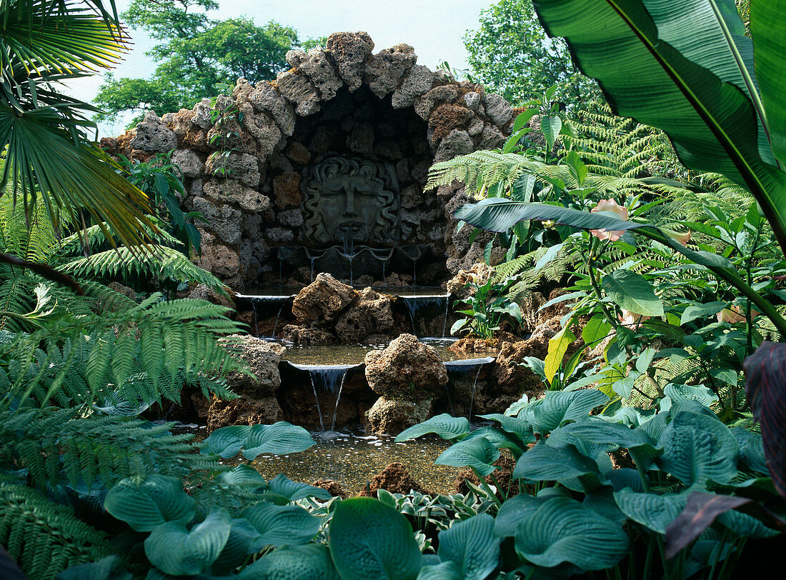 Tufa grotto with water feature, small waterfalls, Hosta (Funkie)