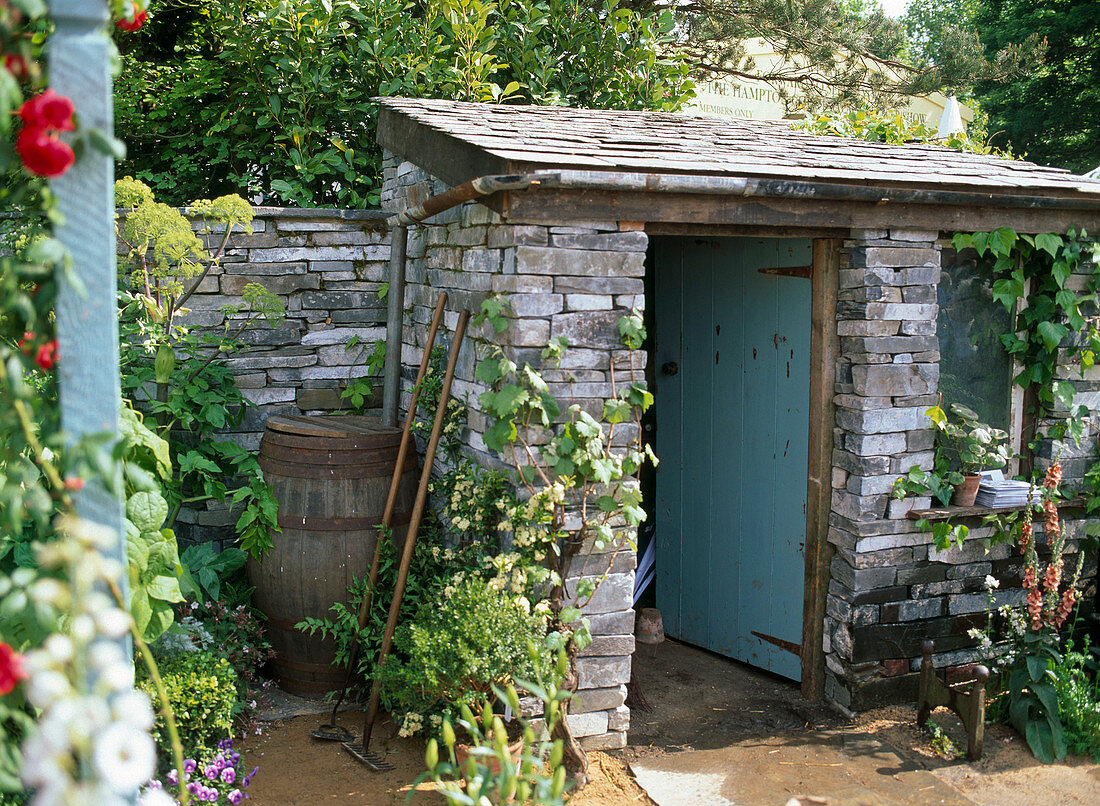 Garden house with rain barrel