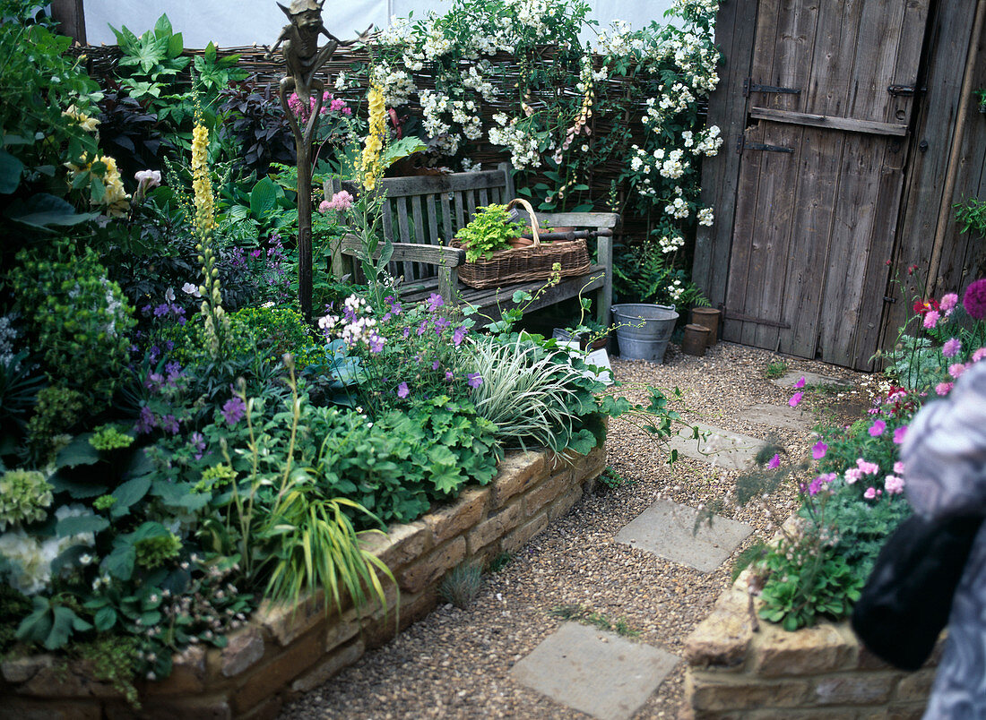 Gravel path with stepping stones and flower bed