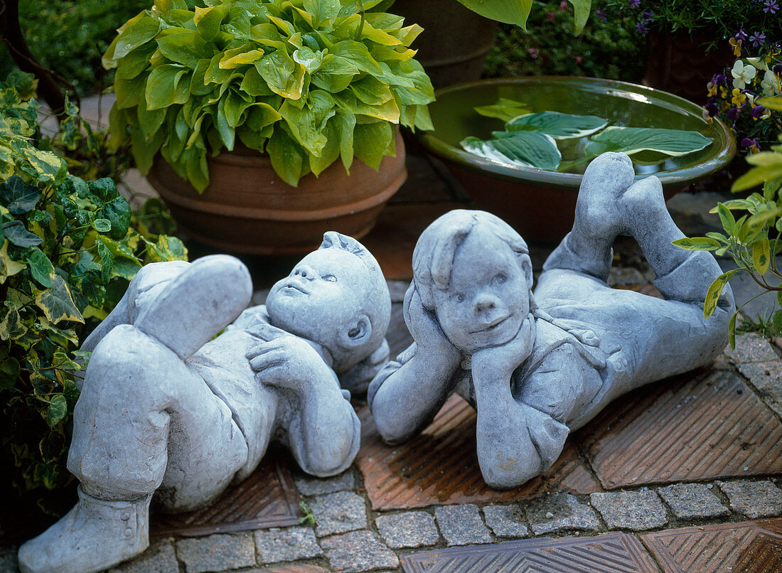 Reclining boys made of cement