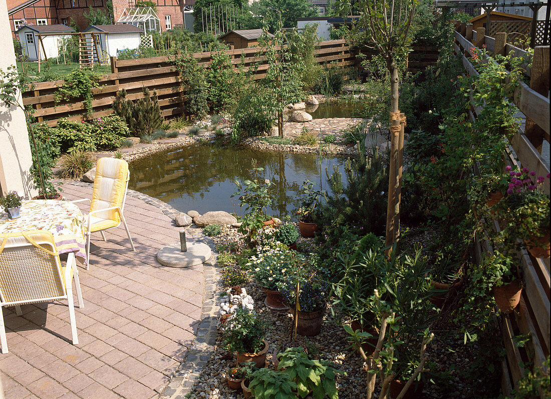 General view of the small garden with terrace and pond