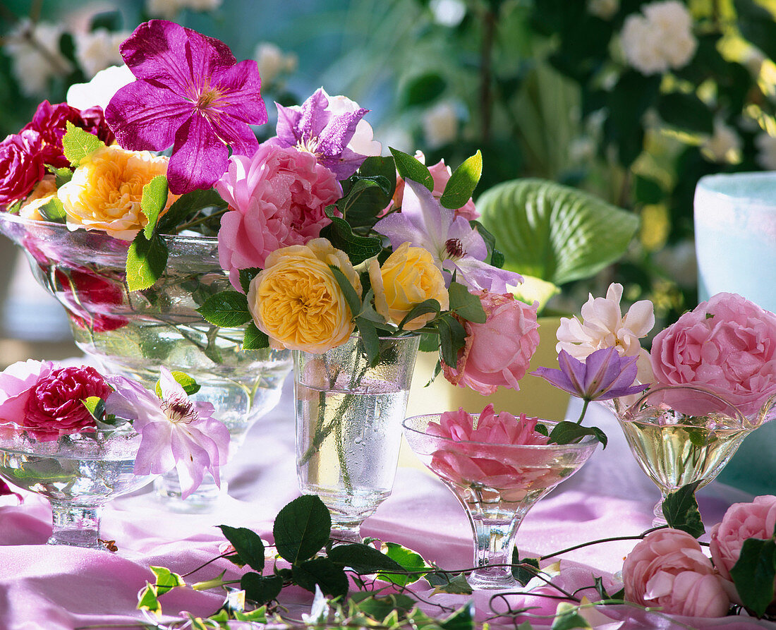 Glass bowls with rose and clematis flowers