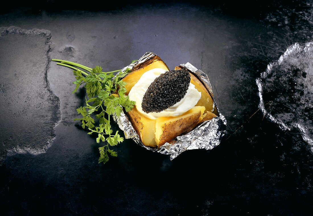 Baked Potatoe mit Creme fraiche & schwarzem Kaviar in Folie
