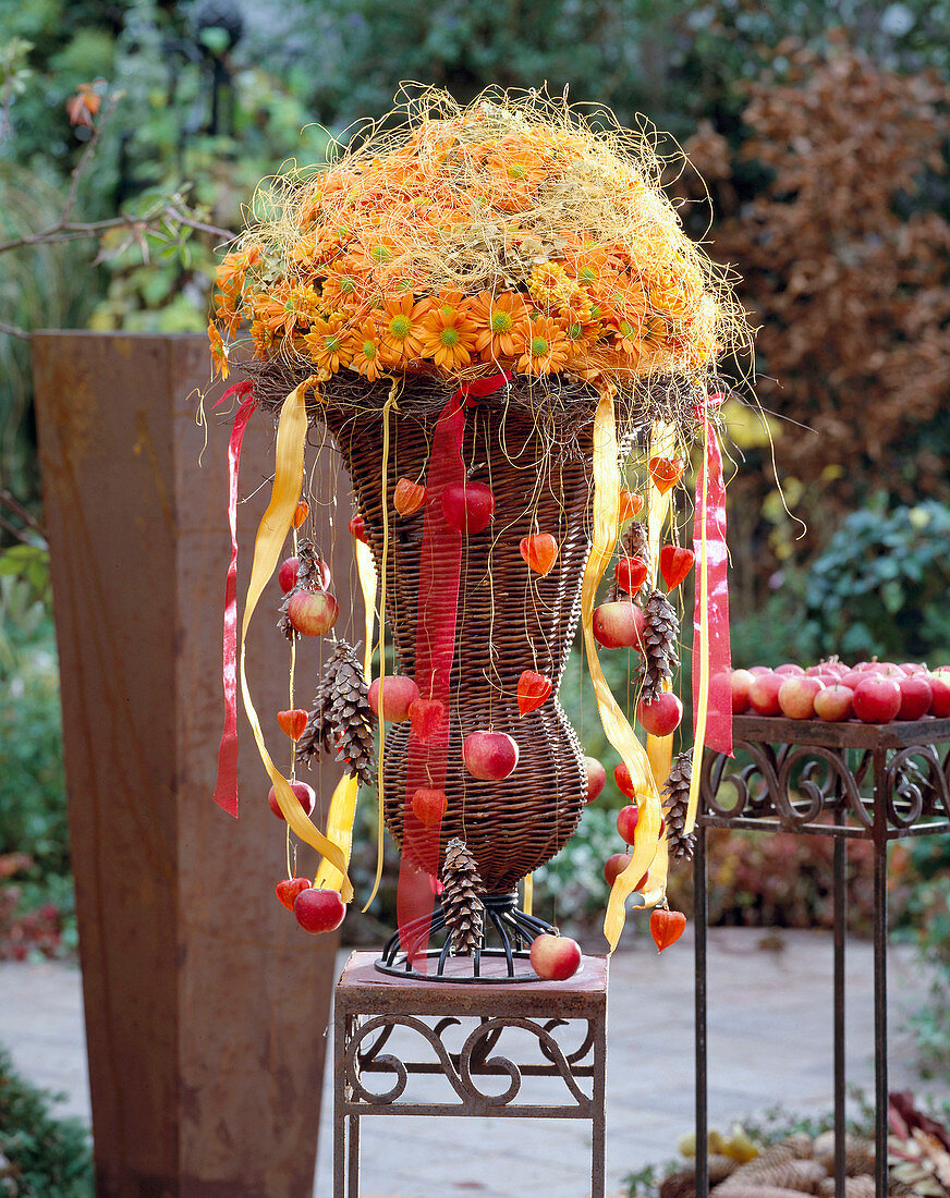 Basket vase with arrangement of autumn chrysanthemums