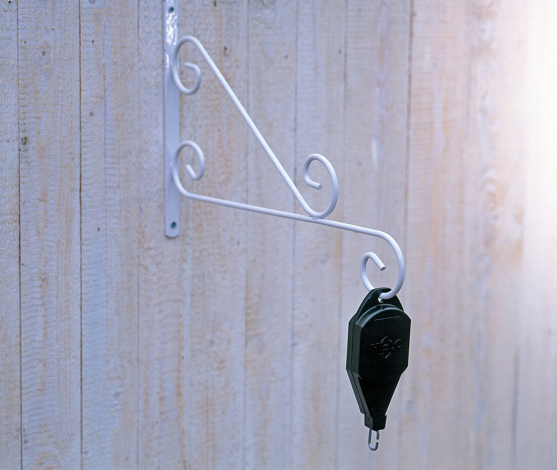 A pulley for hanging baskets so that the baskets can be pulled down when watering.