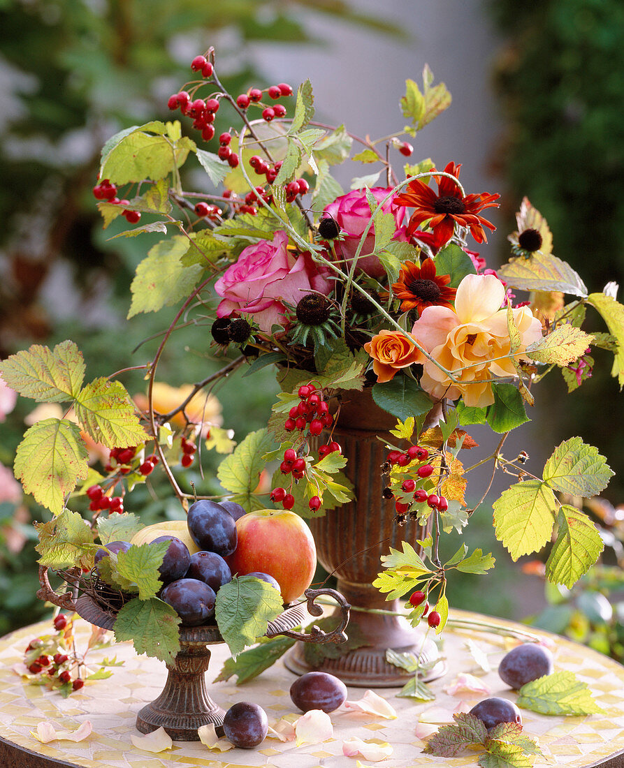 Iron vessels; Rosa (roses) and rosehips, Rudbeckia (coneflower), Rubus (blackberry vine)