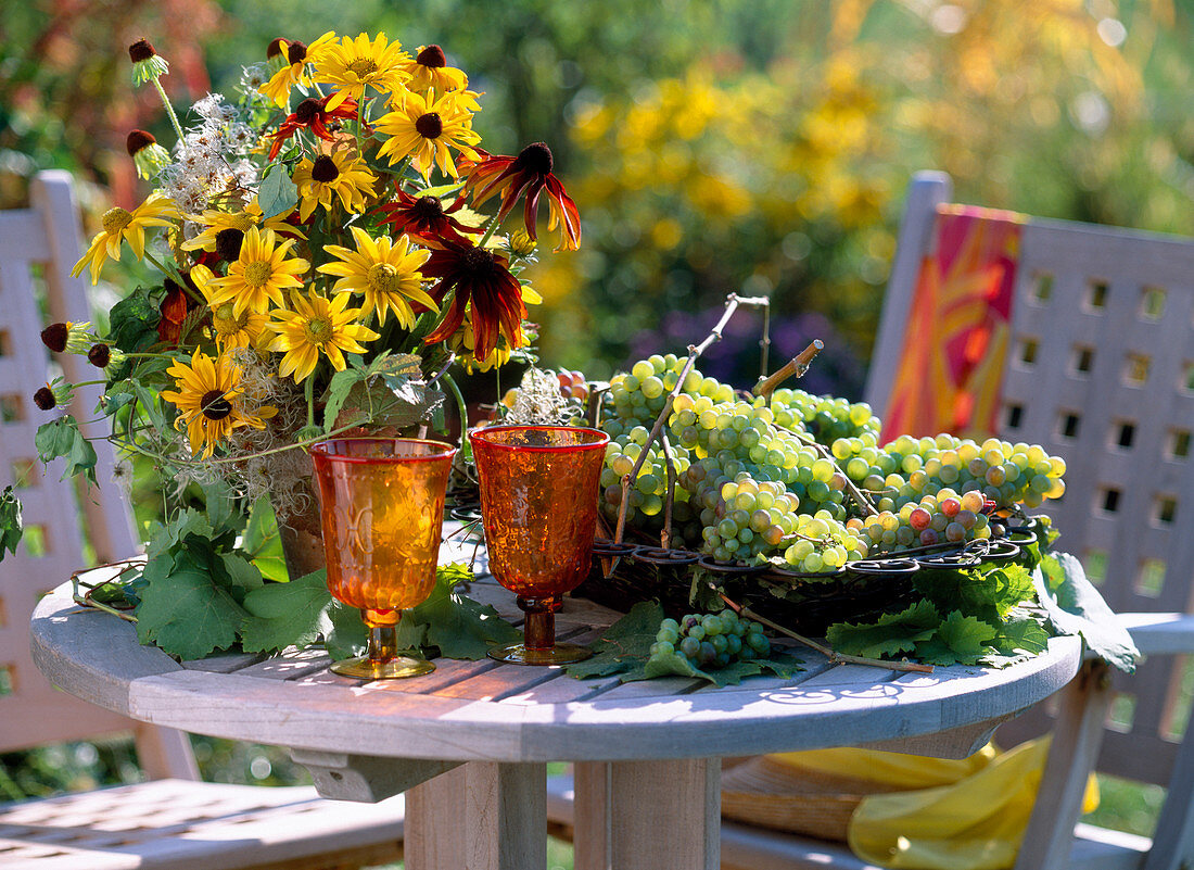 Bouquet with Rudbeckia 'Prairie Sun', 'Autumn Colors', grapes in iron basket