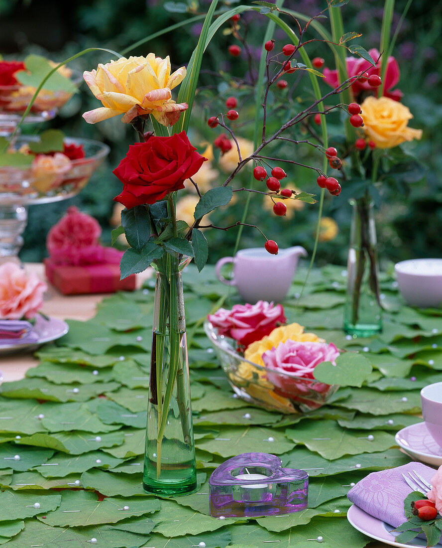 Pink (roses and rosehips in glass vases, bowl and on)