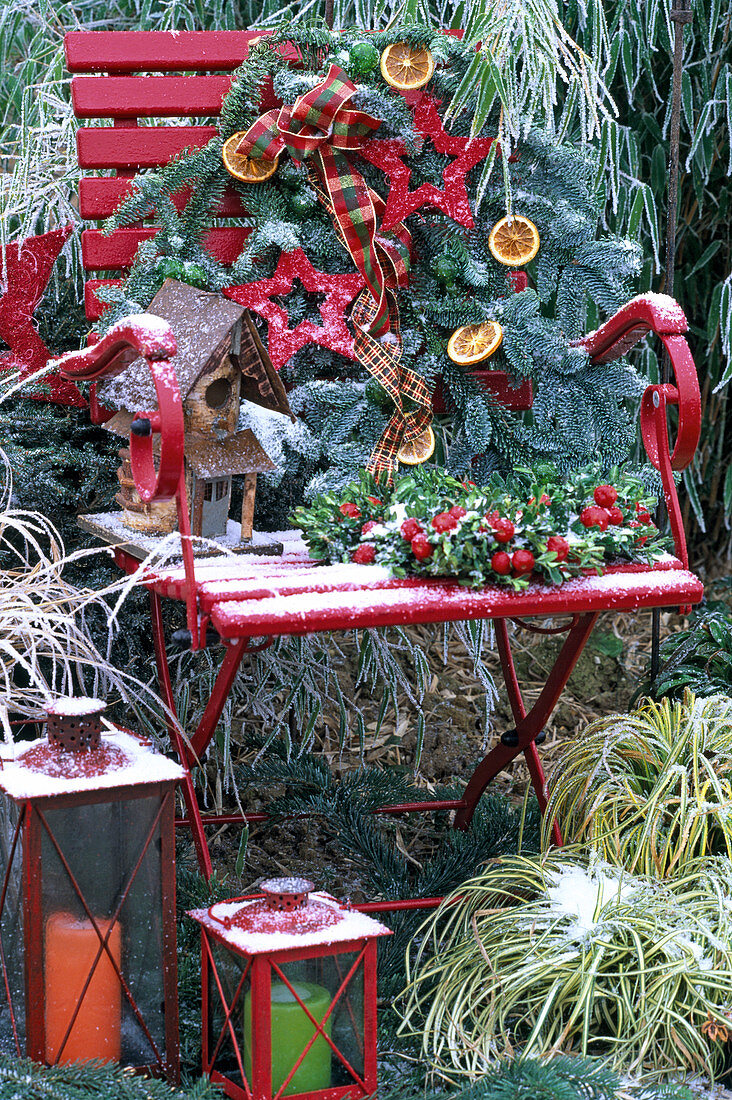 Red chair with fir branch, bows