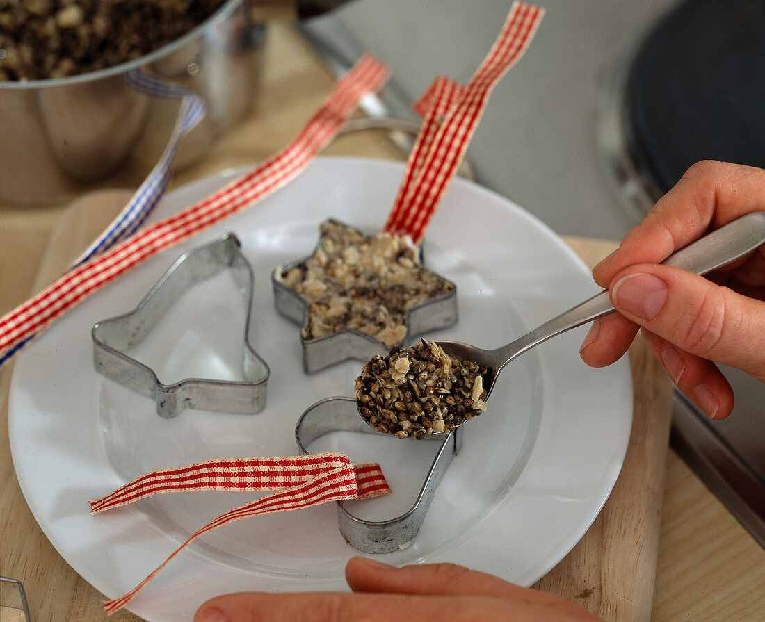 Fird fat ball to hang, fill the grain mixture in baking tin