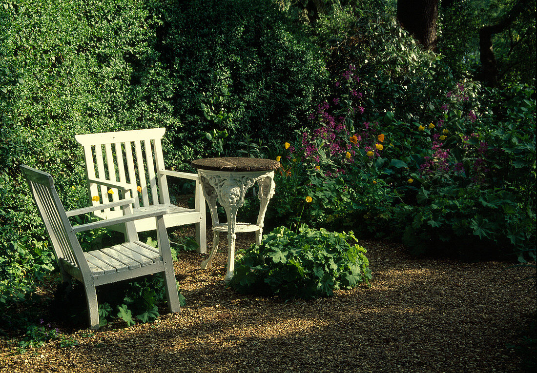 Seat on gravel terrace in the garden