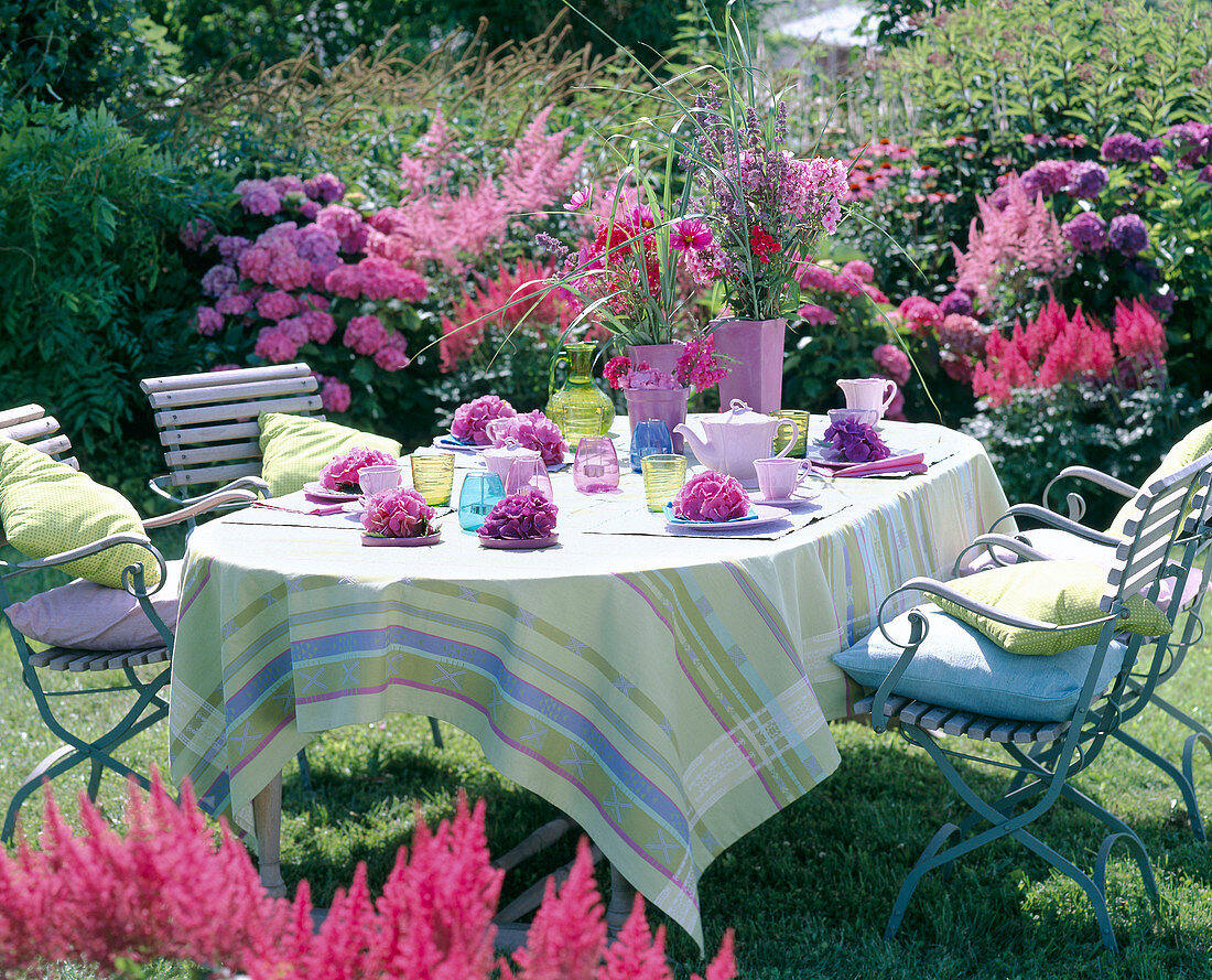 Table in front of flowerbed with hydrangea