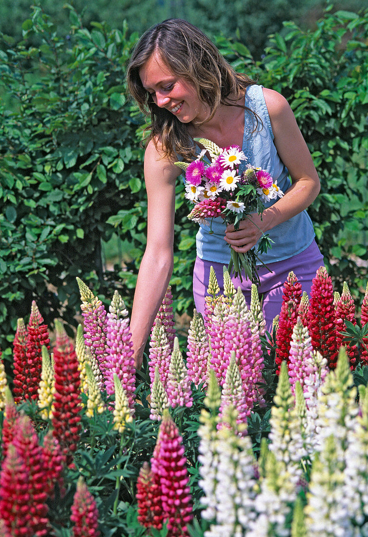 Young woman picks flowers bouquet