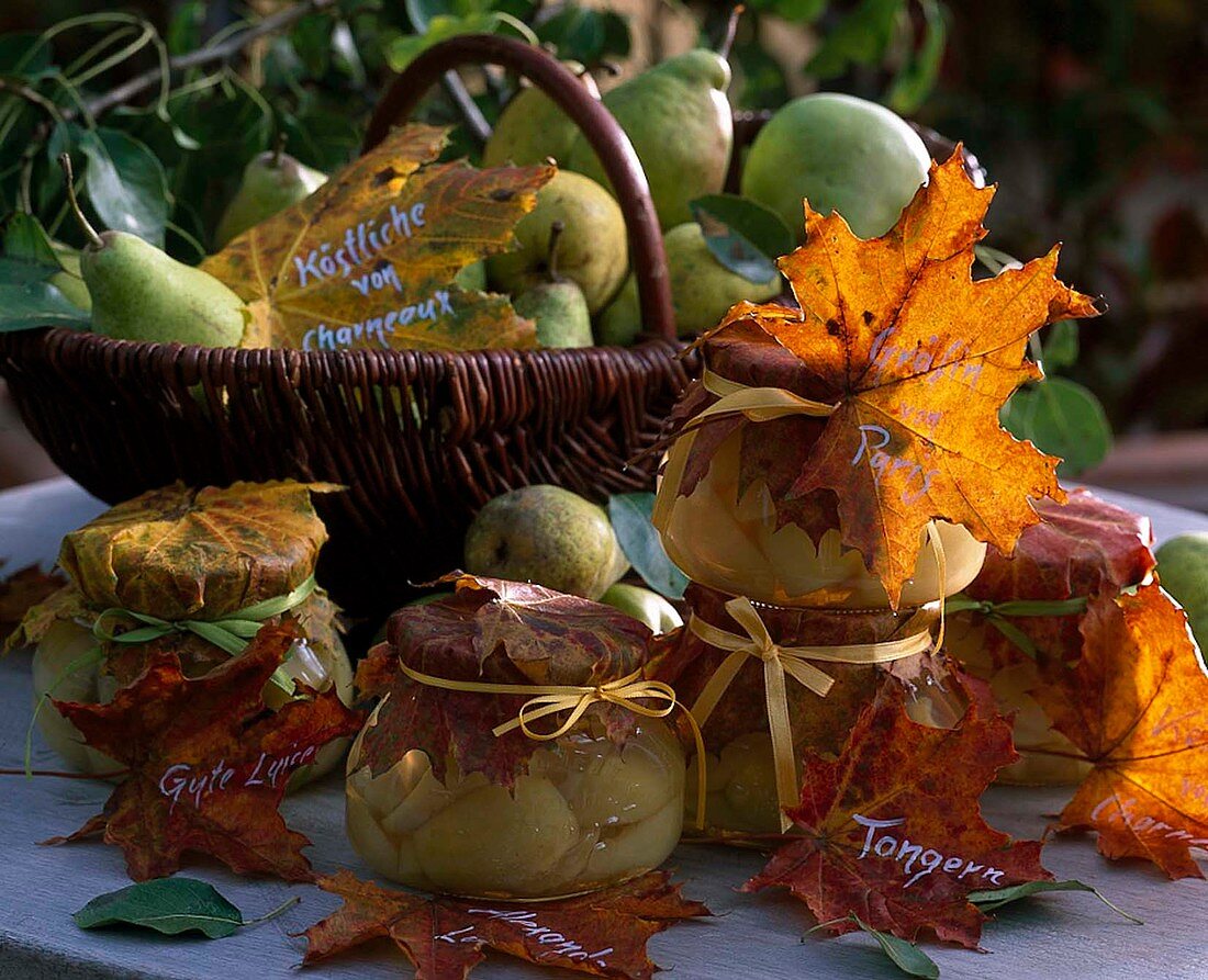 Preserved pears and basket with fruits