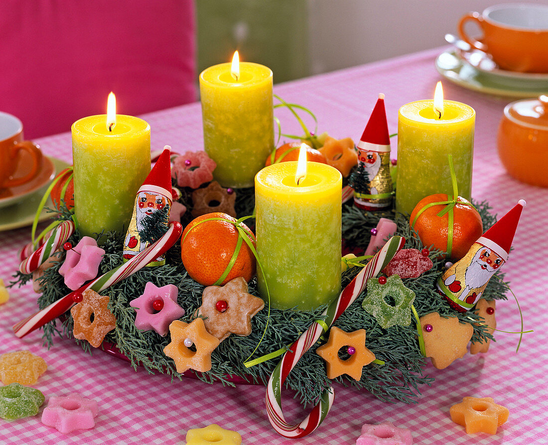 Advent wreath made from Juniperus, with green pillar candles