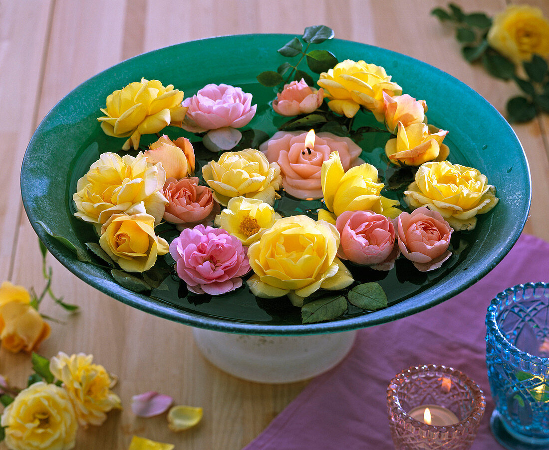 Pink (rose blossoms), floating rose candle, green glass bowl