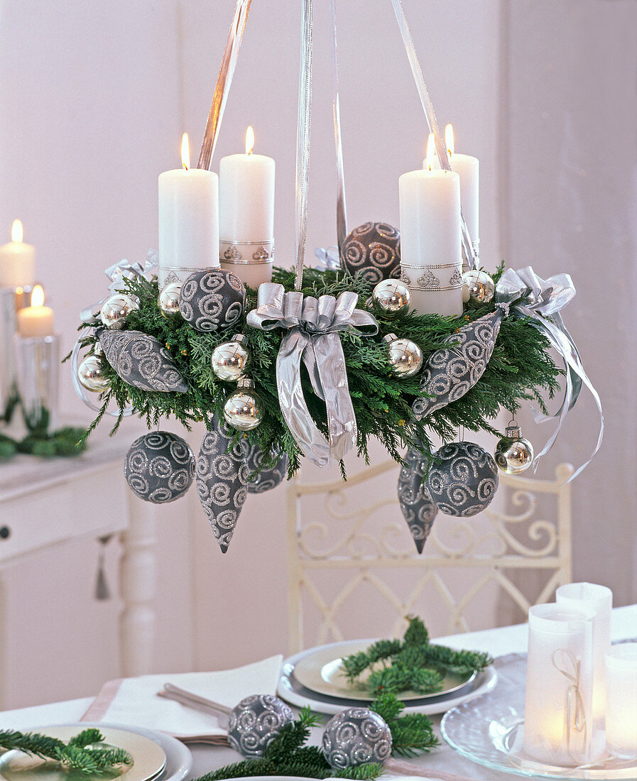 Ceiling wreath with white candles and gray-silver tree ornaments on Cryptomeria
