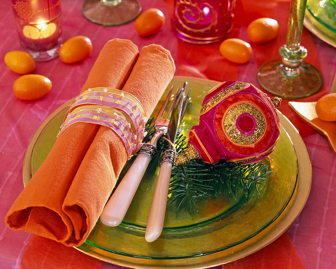 Plate decoration with orange napkin, pine branch