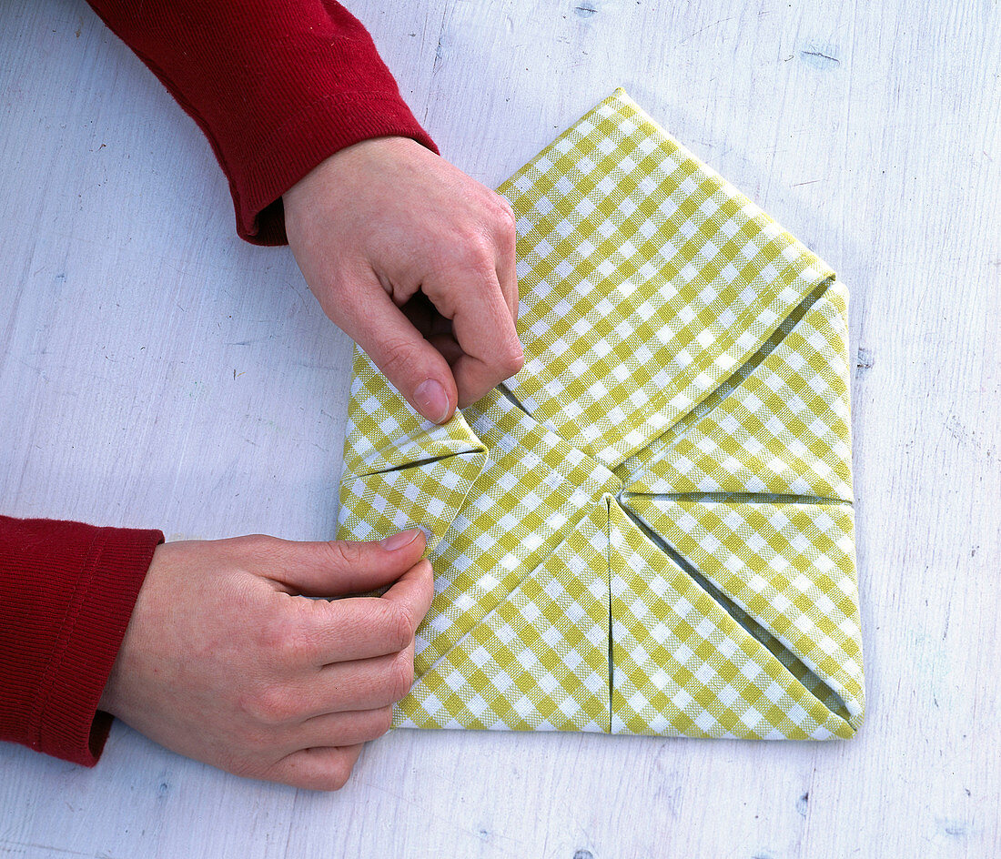 Fold green and white checkered cloth napkin