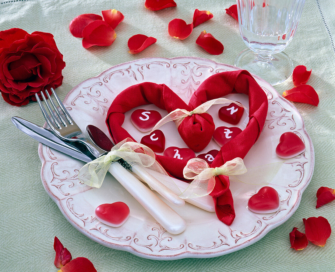 Plate with red napkin tied to a heart