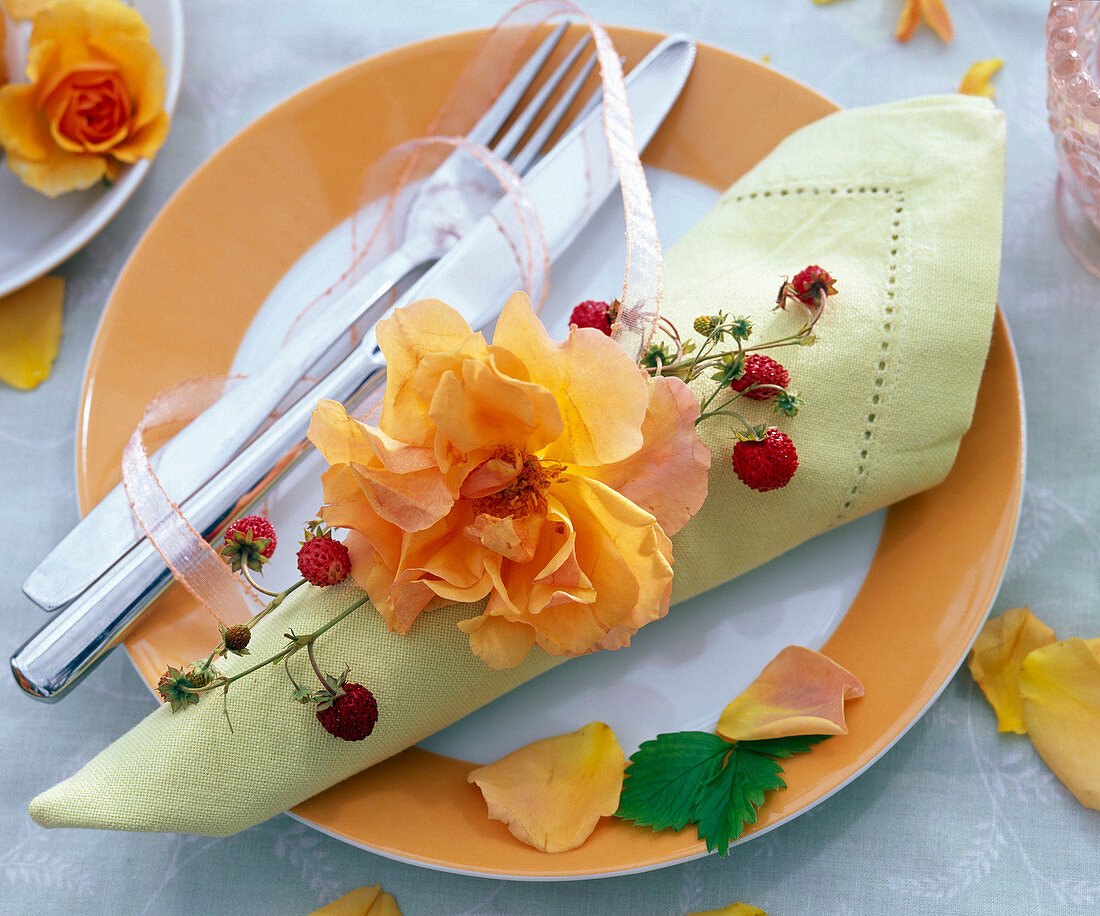 Rose with tendril of Fragaria on light green napkin