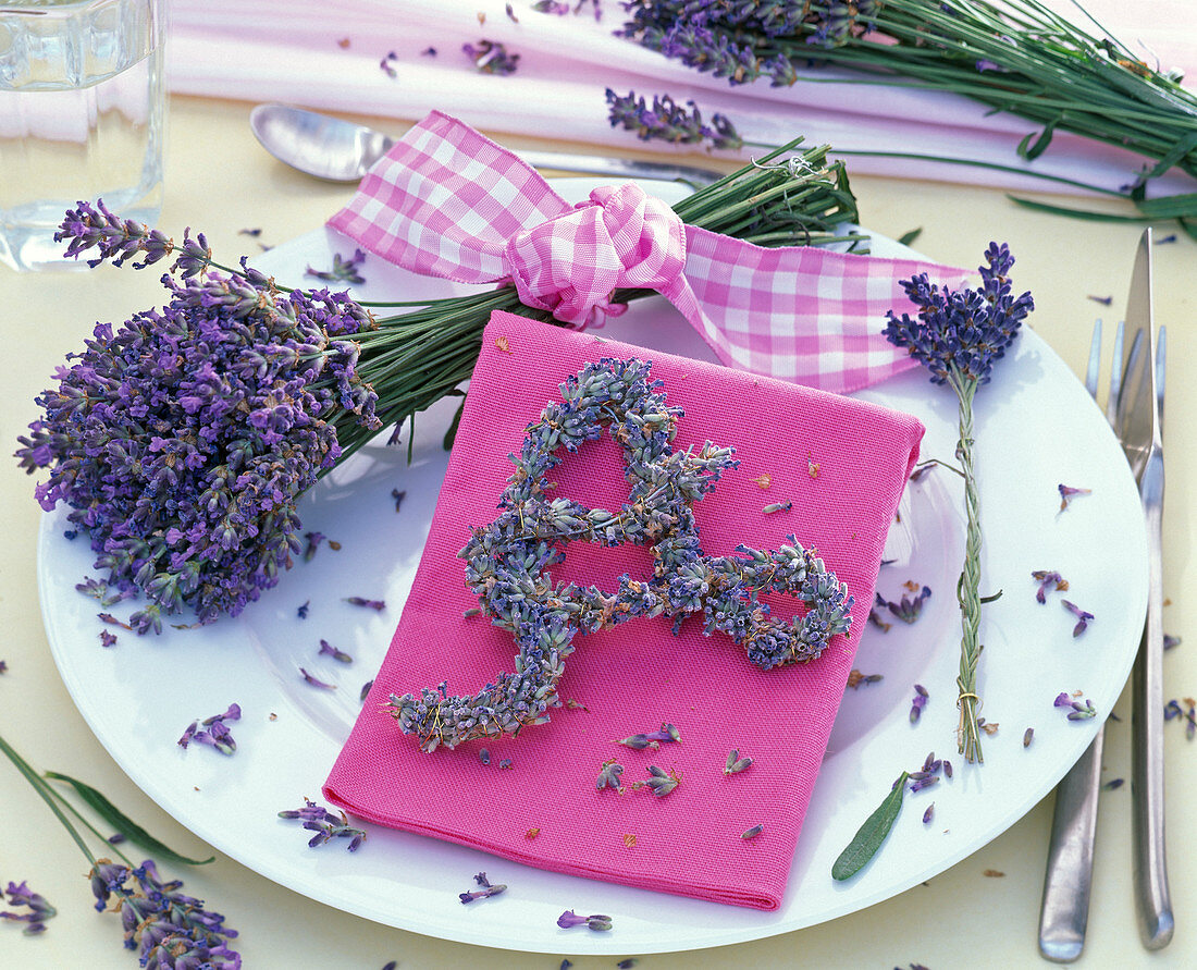 Bouquet and letter 'A' made of lavandula, pink napkin, flowers