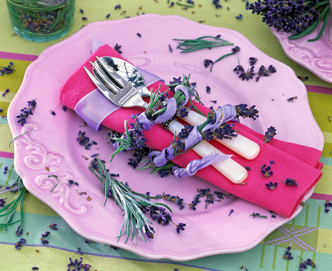 Lavandula as a napkin ring around pink napkin, cutlery