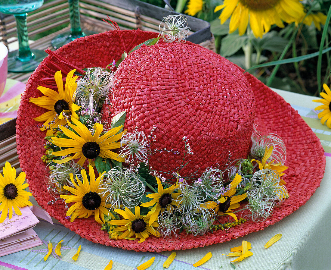 Red straw hat with Rudbeckia, and Clematis wreath