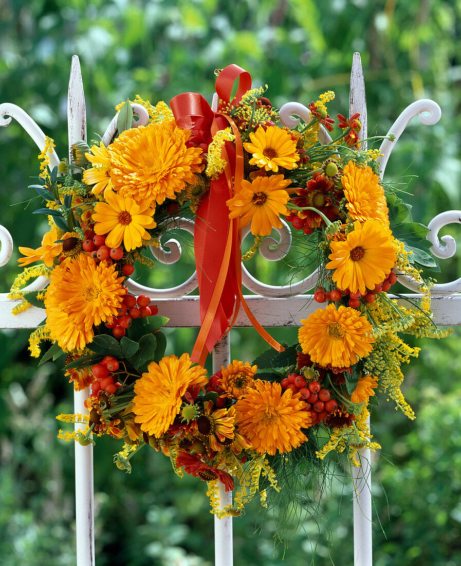 Late summer wreath with marigolds and rowanberries