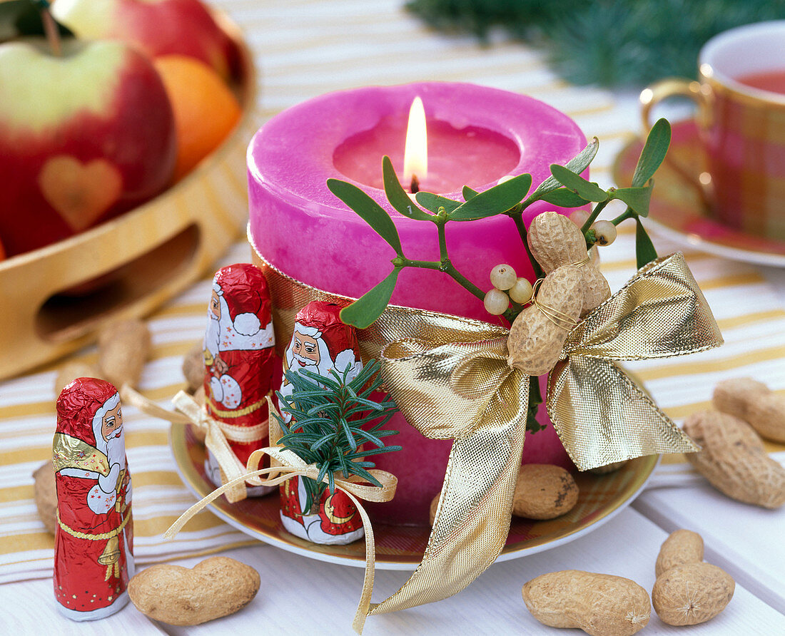 Viscum album (mistletoe), arachis (peanuts), abies (fir) on candle