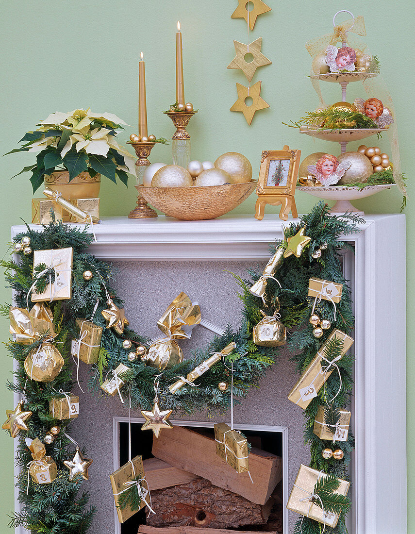 Advent calendar with golden parcels on garland of Chamaecyparis